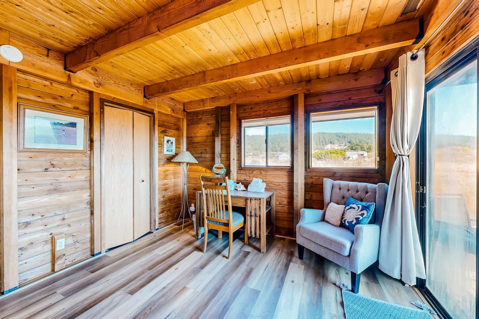 Share stories over tea in this cozy nook, where natural light and warm wood create an inviting atmosphere for intimate gatherings.
