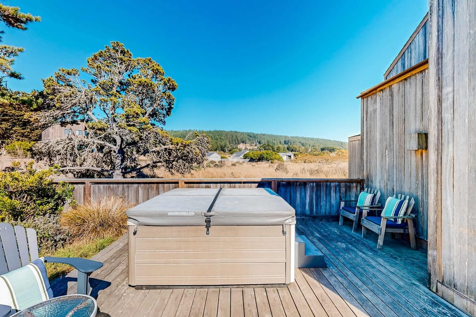Soak in the private hot tub, surrounded by tranquil views, perfect for stargazing after a day of adventure.
