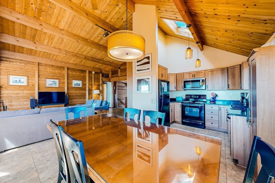 Craft culinary delights in a well-appointed kitchen that blends functionality with coastal charm for your family feasts.