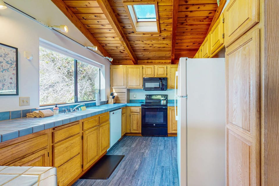 Cook up delicious meals in the well-equipped kitchen, where natural light and a spacious layout inspire culinary creativity.