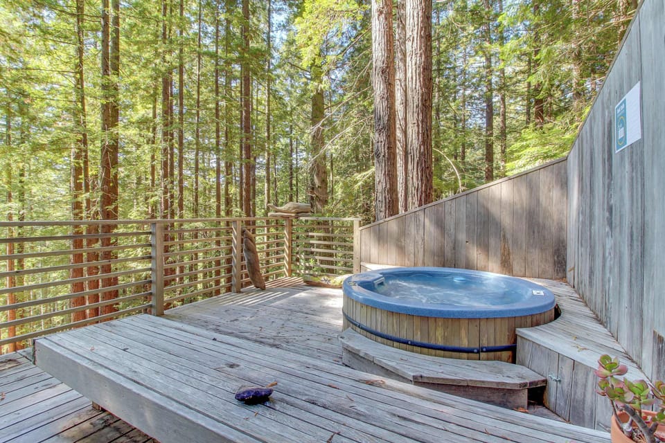 Indulge in relaxation in your private hot tub, nestled among the trees for a truly tranquil experience.