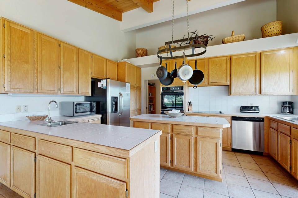 Unleash your inner chef in this well-equipped kitchen, where cooking becomes a pleasure amidst the warmth of natural light.