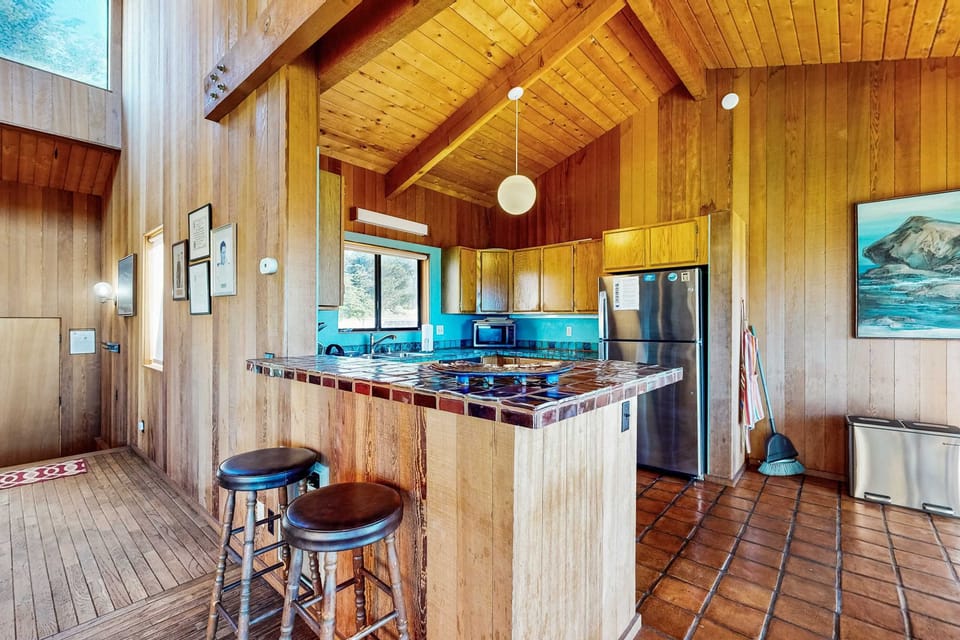 Gather around the kitchen island for casual breakfasts or evening chats, where the ocean view adds to your culinary experience.