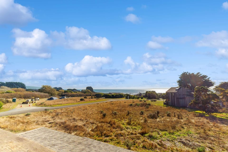 Gaze out over the stunning coastal landscape from Bahari House, where rolling hills meet the sparkling ocean, inviting you to explore the beauty of Sea Ranch.