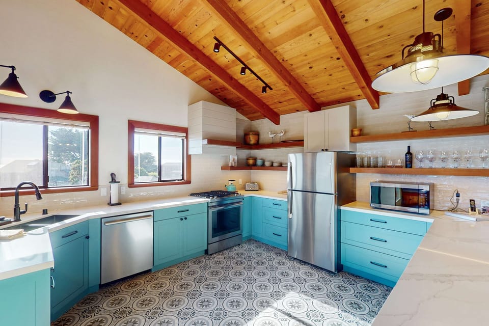 Craft delightful meals in this vibrant kitchen, where coastal colors inspire creativity and the open layout invites everyone to join the fun.
