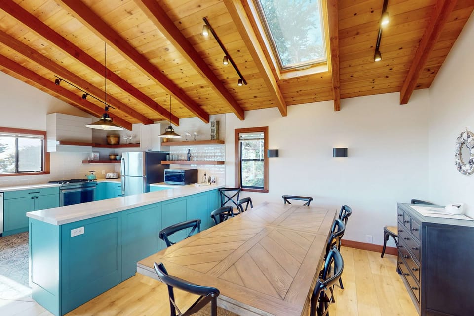 Cook up your favorite dishes in this stylish kitchen, featuring vibrant accents and a spacious dining area for all your culinary adventures.