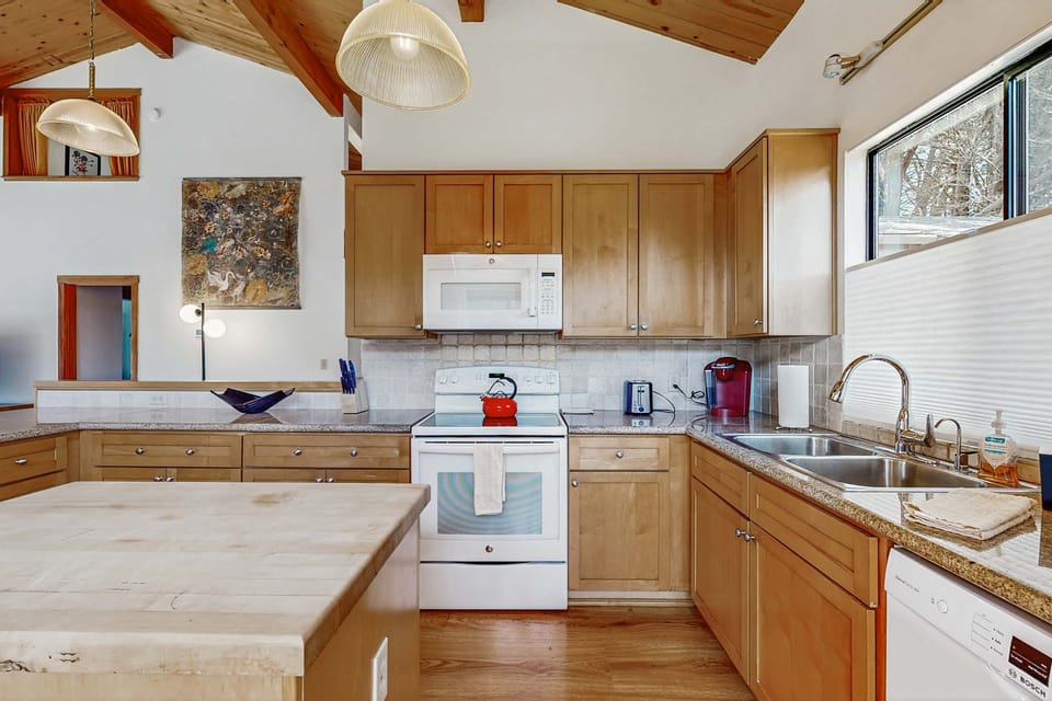 The kitchen’s inviting atmosphere, complete with a central island, is perfect for gathering while preparing your favorite dishes.