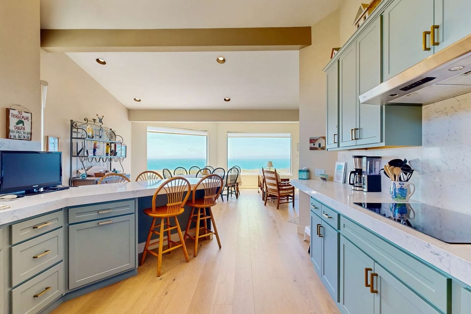 Imagine sipping your morning brew while gazing at the ocean from this spacious kitchen, where every meal feels like a seaside retreat.