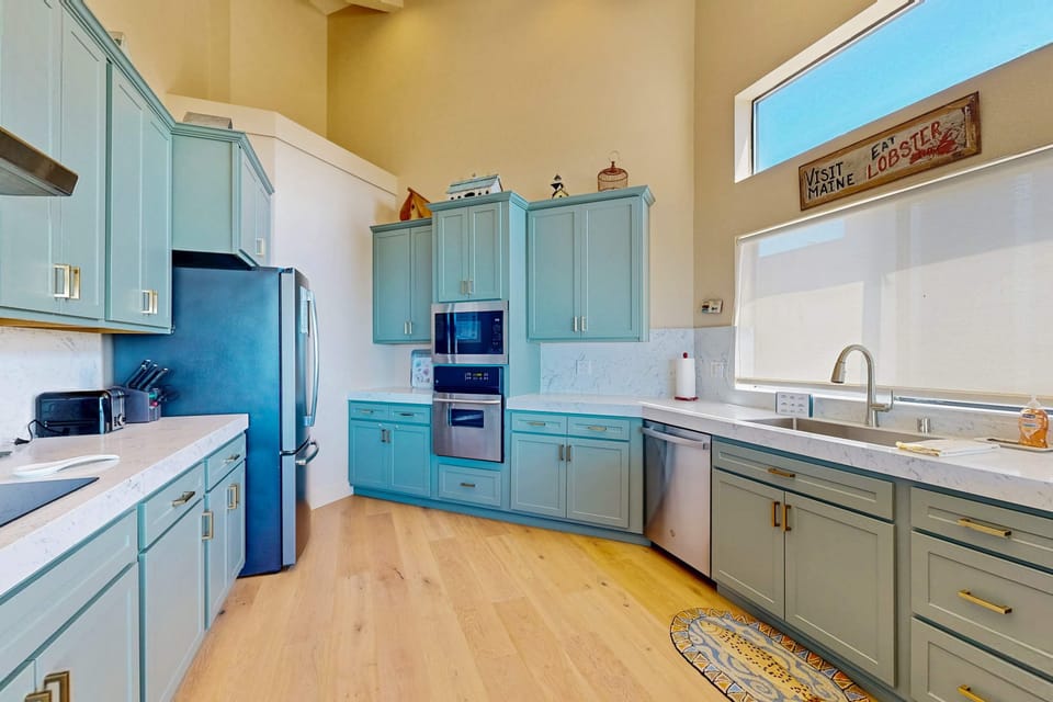 A well-appointed kitchen invites you to gather and create memories, featuring ample space and breathtaking views to inspire your culinary adventures.