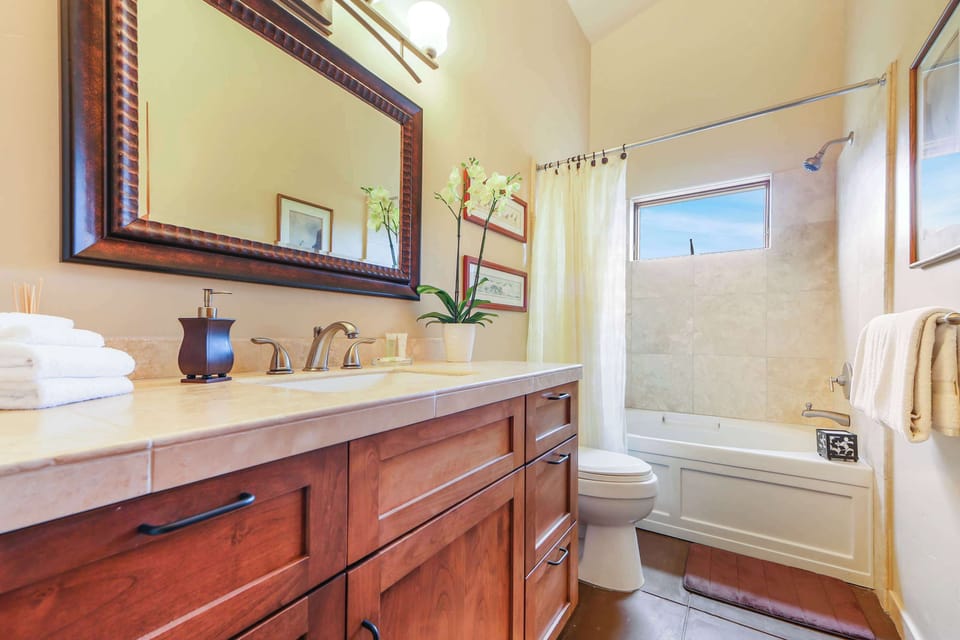 Indulge in a spa-like experience in this beautifully designed bathroom, complete with modern amenities and a tranquil ambiance for your self-care.