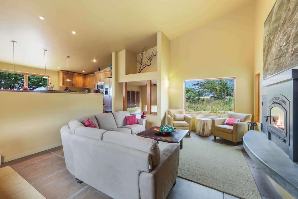 Gather around the wood-burning fireplace in the inviting living room, perfect for cozy evenings after a day of adventure.