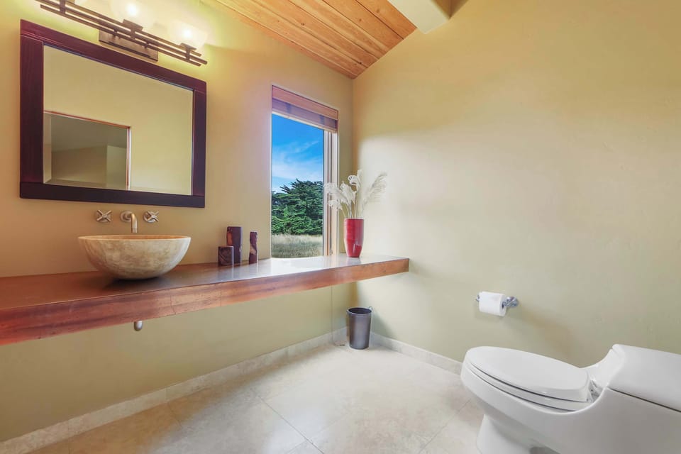 Step into this stylish bathroom, where natural light and modern design create a refreshing space to start or end your day.