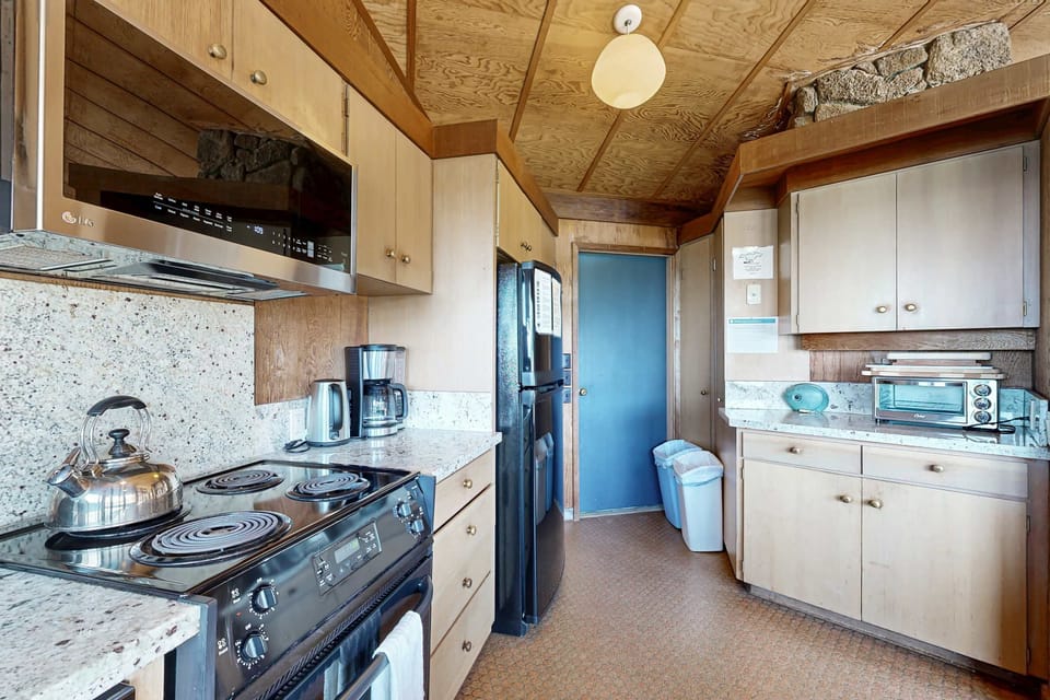 Experience the ease of meal prep in a stylish kitchen, where every glance out the window reveals nature’s beauty.