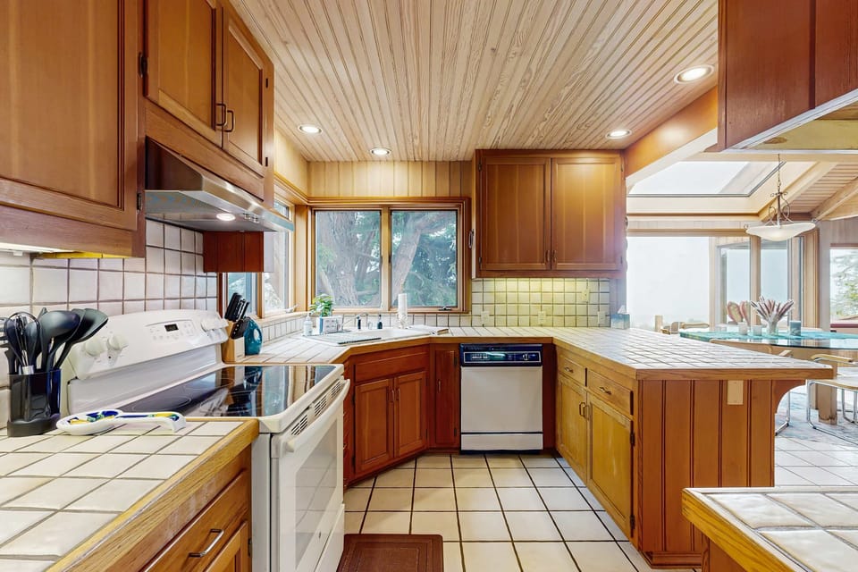 With ample counter space and modern appliances, this kitchen invites you to whip up delicious meals while enjoying the coastal ambiance.