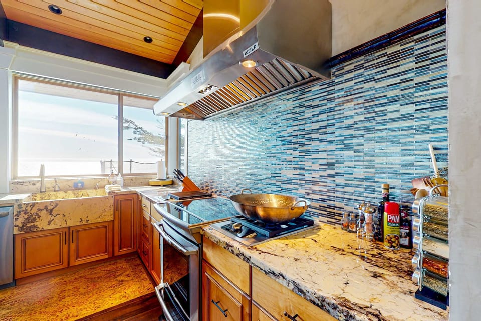 Marvel at the intricate tile work and high-end appliances in this kitchen, designed for both function and breathtaking coastal beauty.