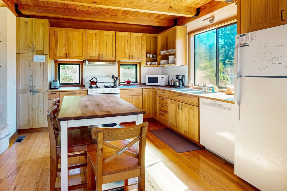 Cook up coastal delights in this well-equipped kitchen, where the sun streams through the window, inspiring culinary creativity.