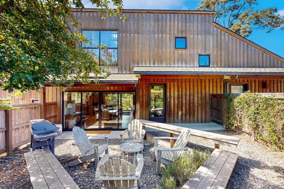 Step outside to your private oasis, where lounge chairs and a fire pit invite you to unwind under the coastal sun.