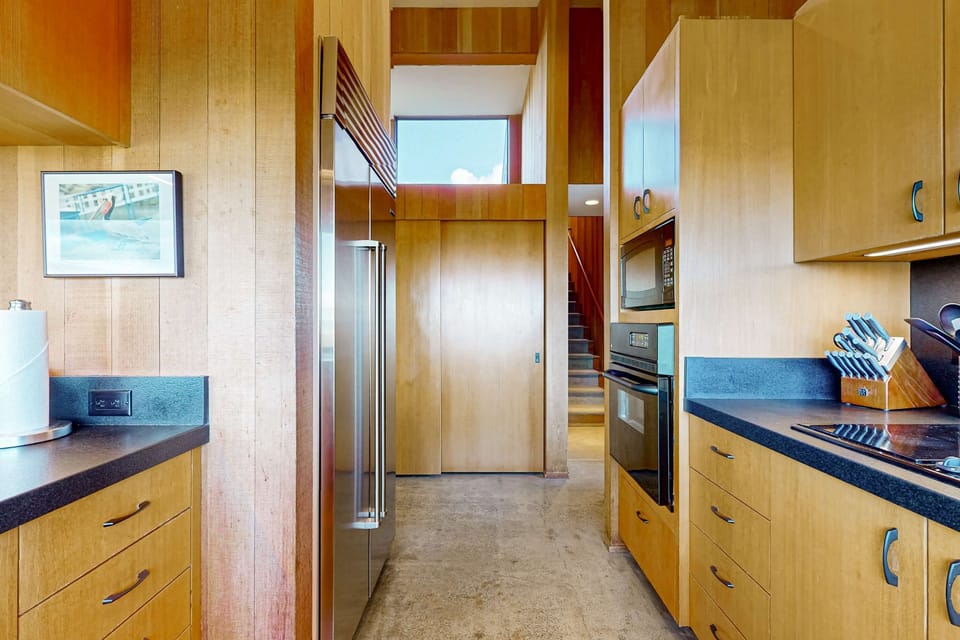 This spacious kitchen flows effortlessly, providing ample room to whip up your favorite dishes while enjoying the coastal scenery.