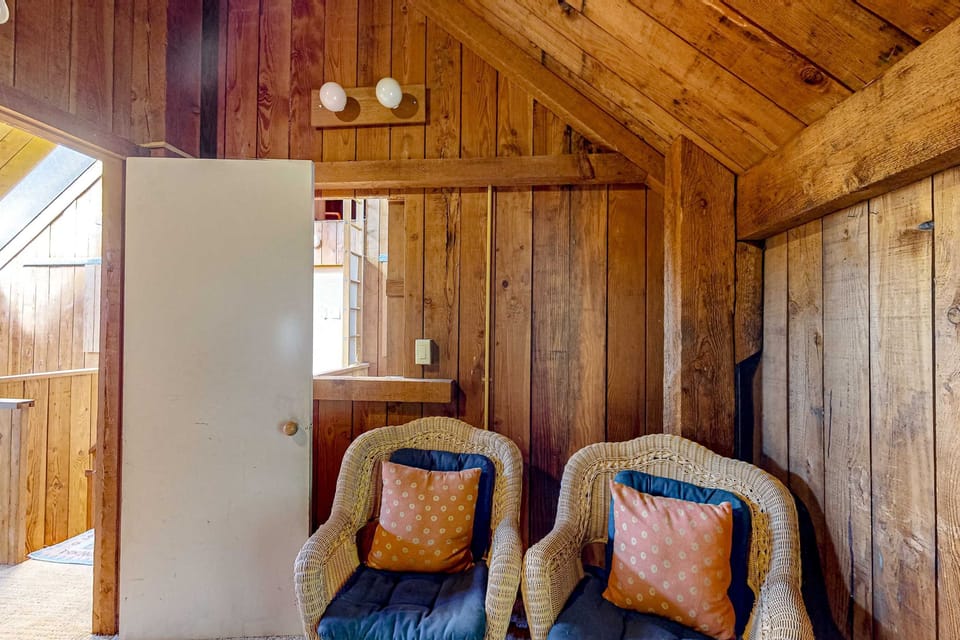 Nestle into the comfy chairs, perfect for evening chats or quiet moments, where the warmth of wood creates a peaceful retreat.