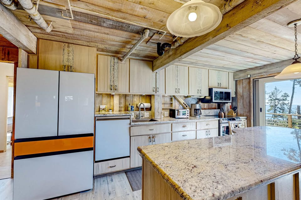 Whip up delightful meals in this airy kitchen, where ocean views and modern amenities inspire your culinary adventures.