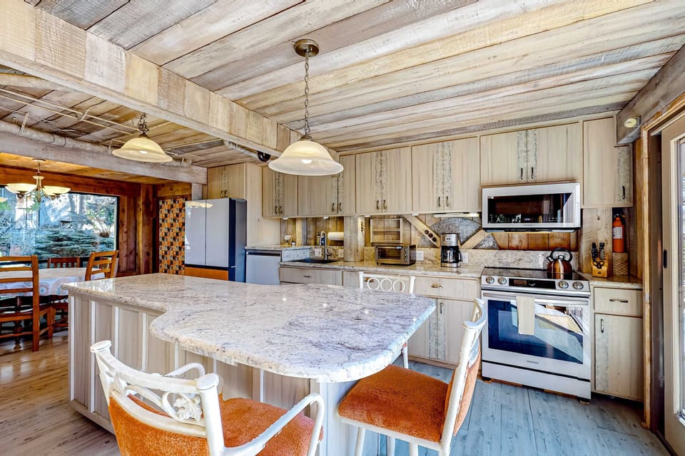 Cook up a culinary masterpiece in this spacious kitchen, featuring modern appliances and ample counter space for your meal preparations.