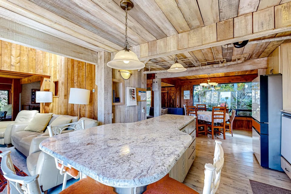 Savor morning coffee at the island bar while soaking in the natural light and coastal views that inspire your day ahead.