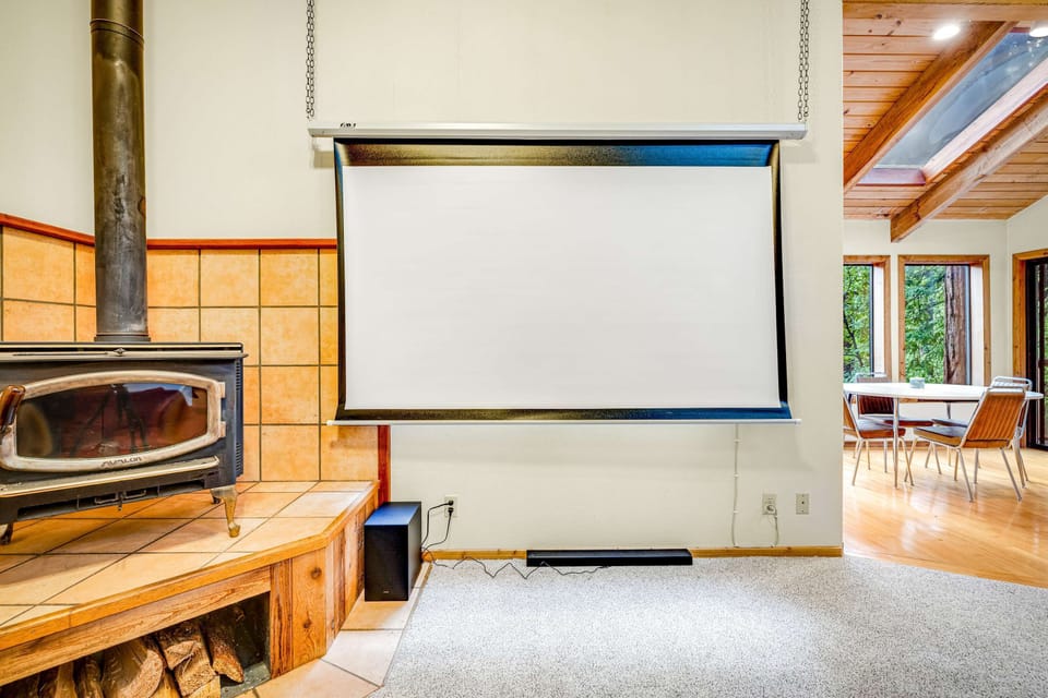 The living room features a convenient retractable screen, ready for your favorite films or game nights with loved ones.