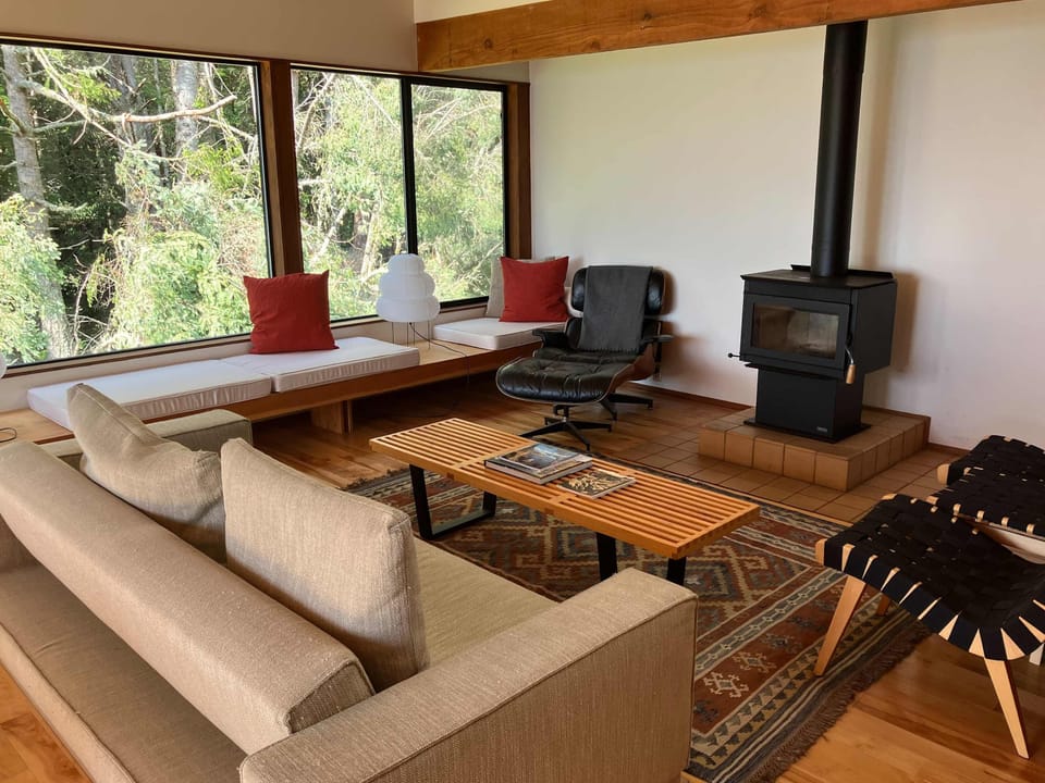 Cozy up in the living room, where a modern fireplace invites you to unwind after a day exploring the stunning coastal trails.