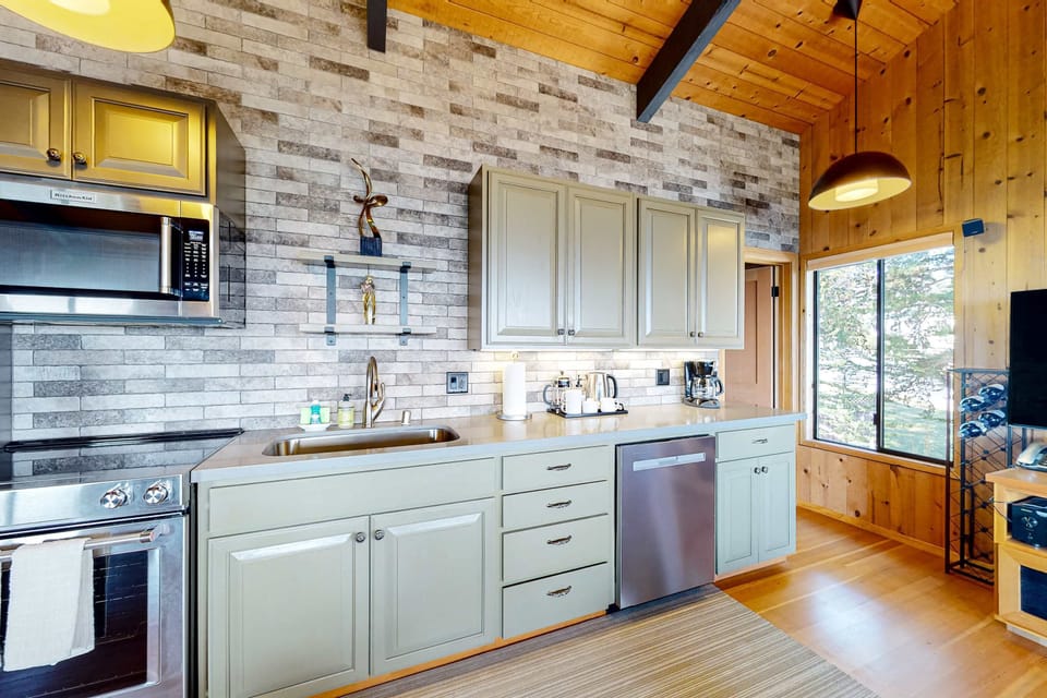 Natural light fills this inviting kitchen, making meal prep a joy while you soak in glimpses of the serene coastal landscape.