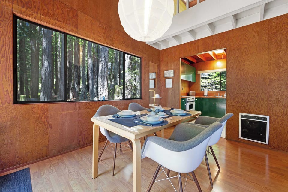 Come together around the dining table, where the warmth of wood and views of nature create an inviting atmosphere for shared experiences.