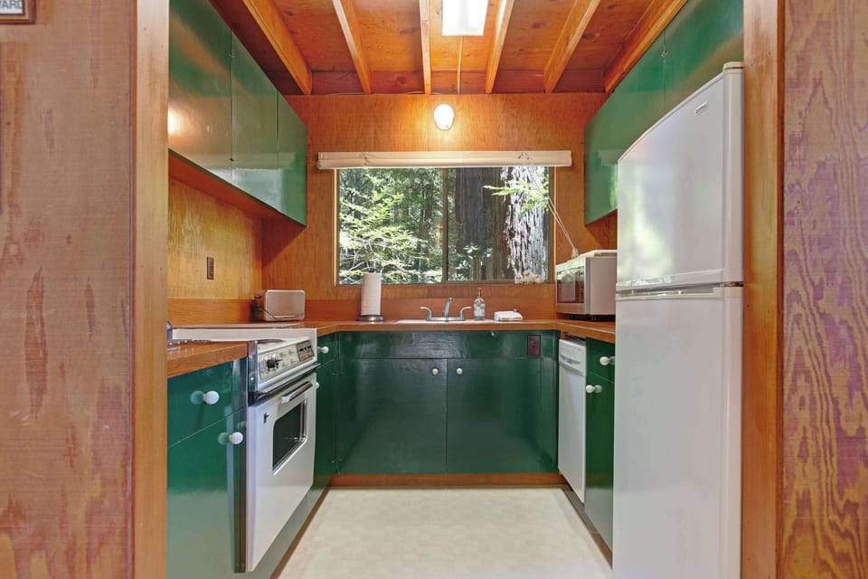Whip up your favorite meals in the well-equipped kitchen, where the vibrant colors and natural light create an inviting space for culinary creativity.