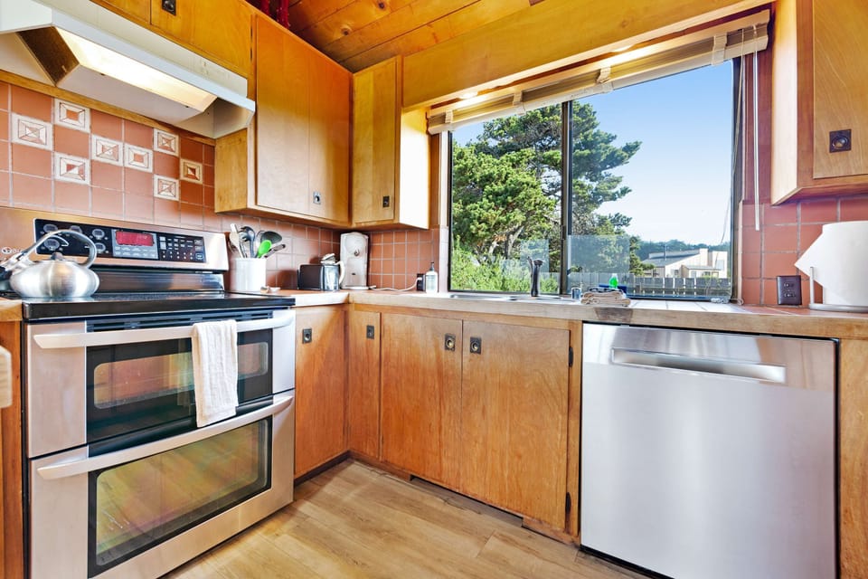 Bright and airy, this kitchen invites you to whip up breakfast and savor it with ocean views just beyond the window.