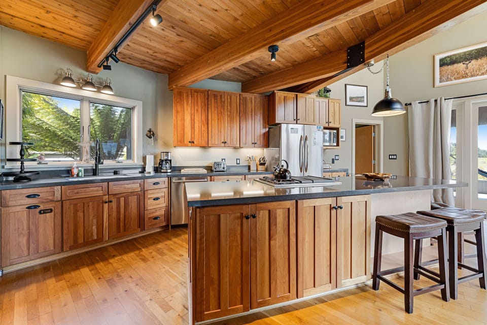Cook up your favorite meals in this modern kitchen, featuring ample counter space and stunning views to inspire your culinary adventures.