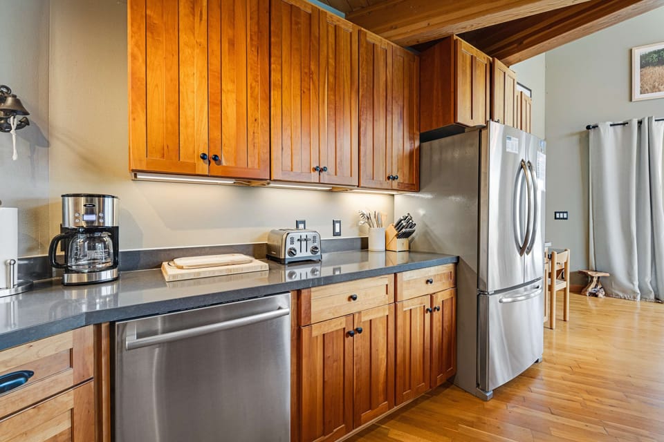 Prepare your favorite meals in this stylish kitchen, where natural light and modern amenities inspire culinary creativity.