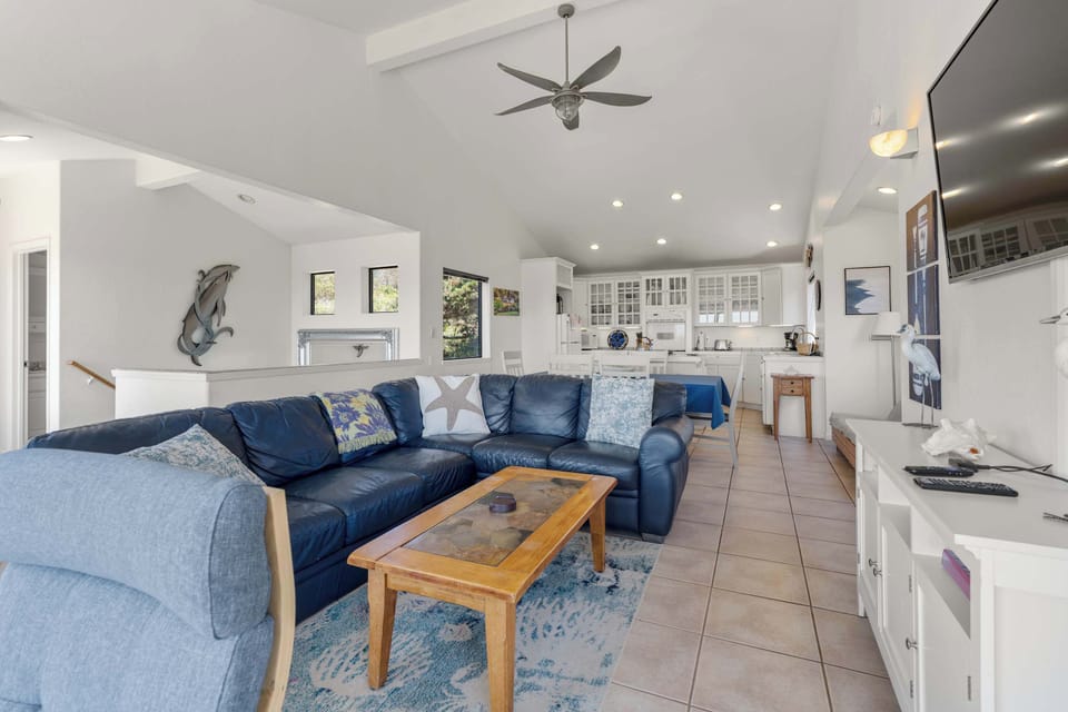 Spread out across the open living space at Casa Del Mar, where tile floors, a roomy sectional, and a sunlit kitchen all flow together.