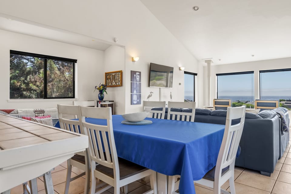 Linger over dinner at the table while the ocean glows blue through the far windows, the living room just a few steps away.