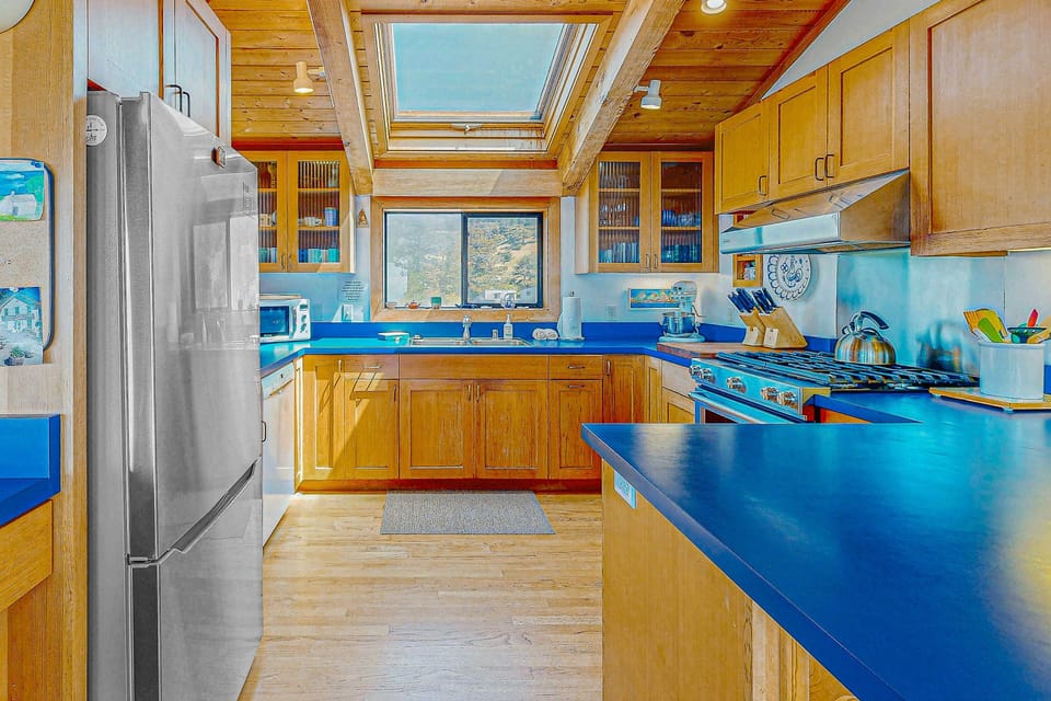 Craft culinary delights in the bright kitchen, designed for both function and inspiration, with ocean views just beyond.
