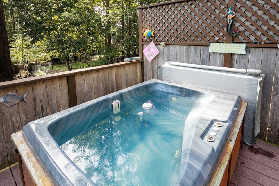 Soak in the warmth of your private hot tub, surrounded by nature’s beauty, perfect for unwinding after a day of coastal adventures.