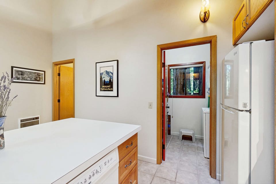 Step into this inviting kitchen, where you can whip up your favorite meals amidst a backdrop of calming forest vibes.