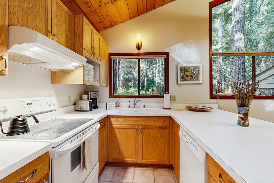 A charming kitchen awaits your culinary adventures, featuring modern appliances and a serene view that makes cooking a joy.