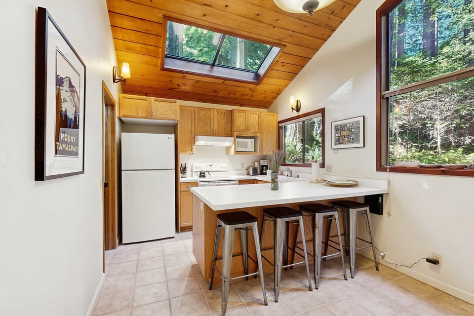 Come together around the kitchen island for casual breakfasts or late-night snacks, enjoying the peaceful ambiance that the forest provides.