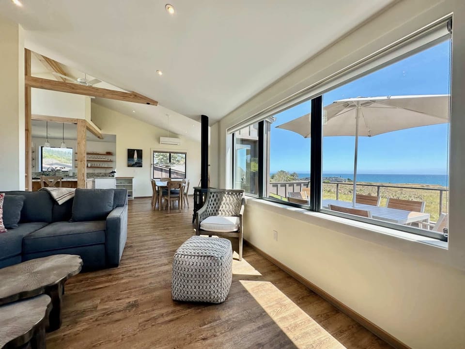 Bask in the warmth of natural light as you relax in the living room, where panoramic ocean views set the perfect ambiance for your getaway.