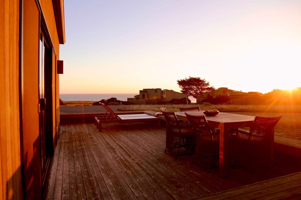 Bask in the stunning sunset from your expansive deck, the perfect spot for evening conversations and ocean views.