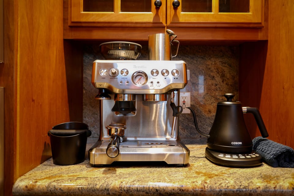 Dial in your latte at the dedicated coffee bar — Breville espresso machine and Cosori gooseneck kettle ready for early risers.