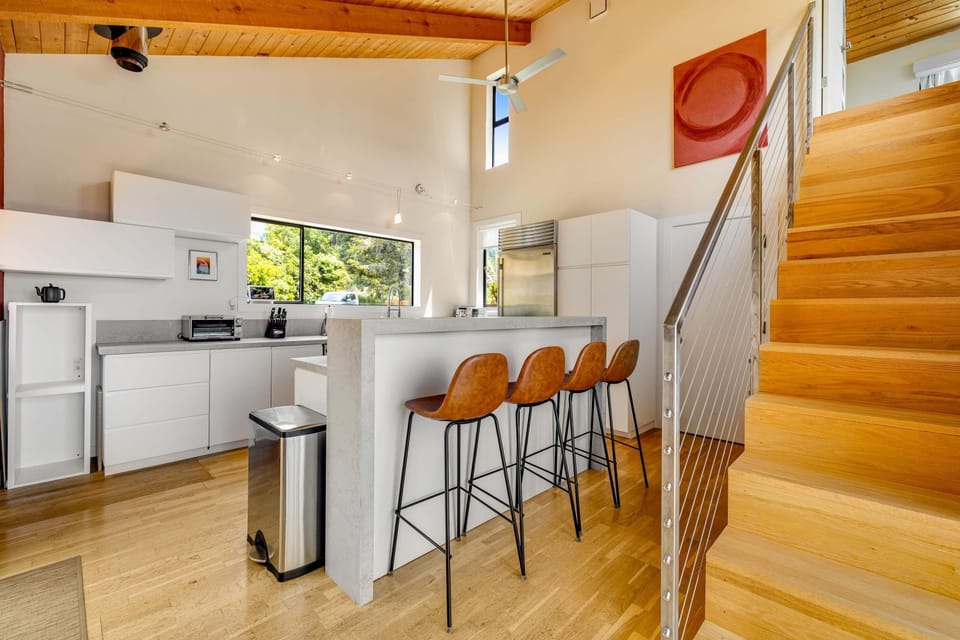 Cook up culinary delights in this modern kitchen, where sleek design meets functionality, allowing you to create memorable meals.