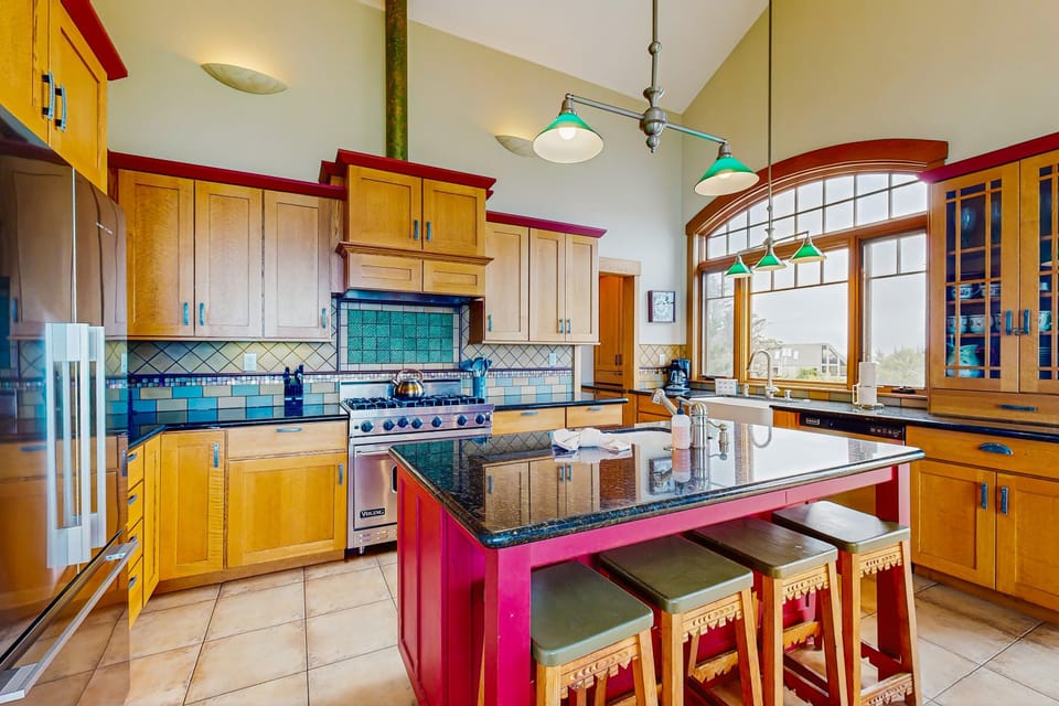 The stylish kitchen invites you to gather and cook, featuring a spacious island perfect for casual breakfasts or evening conversations.