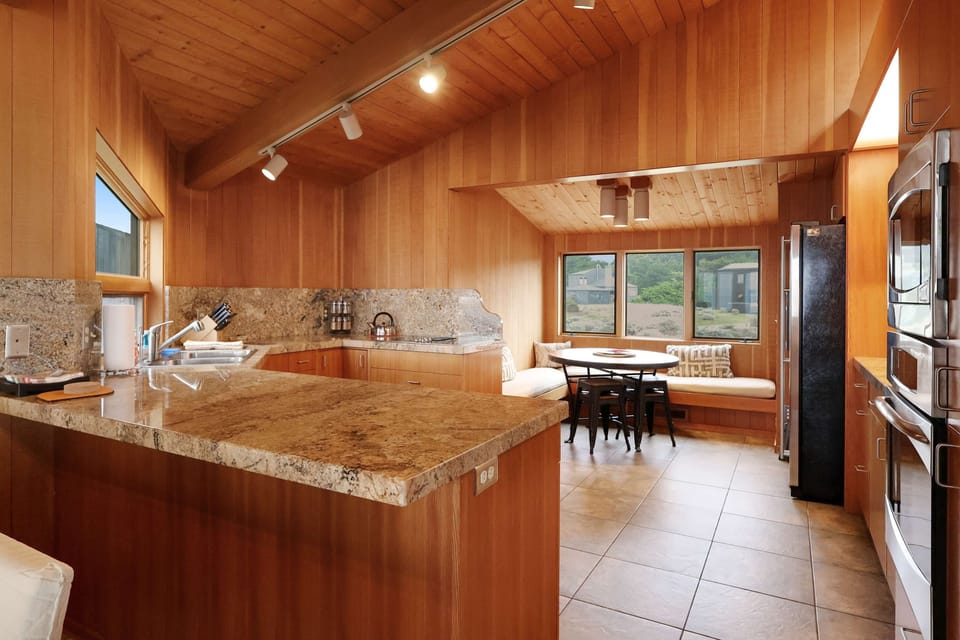 Cook up your favorite meals in the spacious kitchen, where modern amenities meet the warmth of wooden accents.