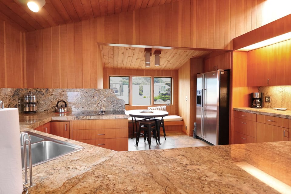 Whip up culinary delights in a bright kitchen that boasts modern appliances and a cozy breakfast nook, inviting conversations over meals.
