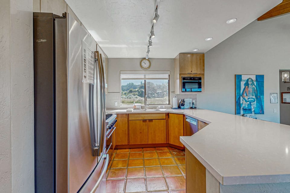 Enjoy the convenience of this modern kitchen, designed for both functionality and inspiration, with nature as your backdrop.