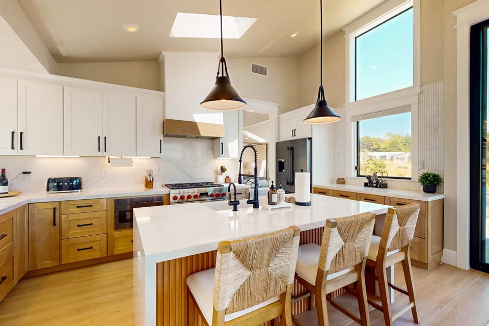 Your culinary adventures begin in this sunlit kitchen, where cooking is a pleasure against a backdrop of nature.